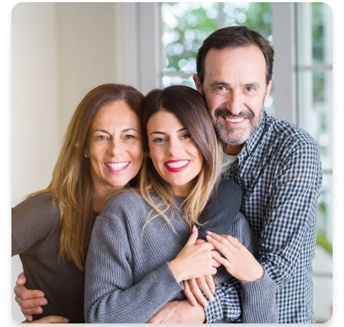 A family of father, mother and daughter hugging